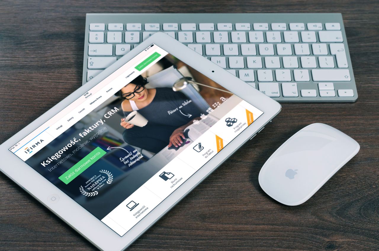 about-us-02 A tablet with a financial website open, alongside a white keyboard and mouse. Ideal for tech-theme stock images.